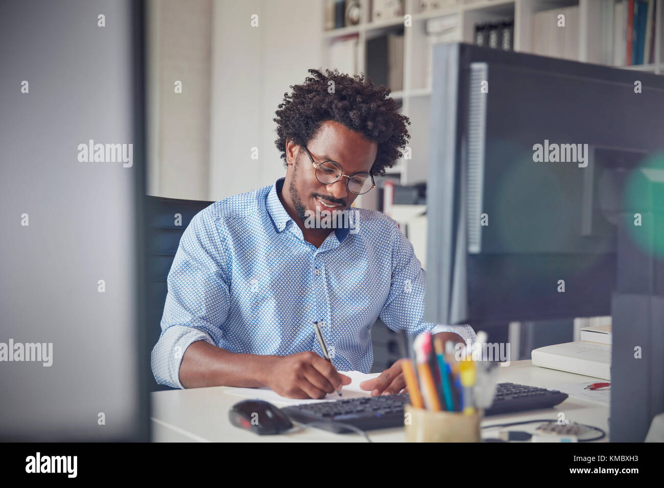 Note Taking Business Computer Businessman taking notes at computer in office Stock Photo - Alamy
