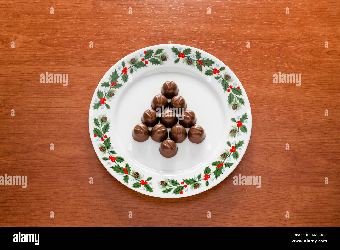 Close up of a plate with christmas decorations and with chocolate cookies in tree shape. Stock Photo
