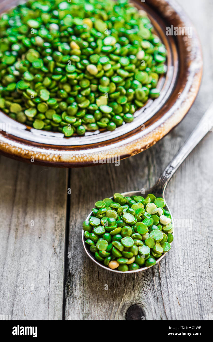 Organic split peas on wooden background Stock Photo - Alamy