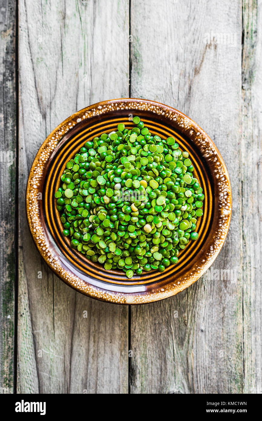 Organic split peas on wooden background Stock Photo - Alamy