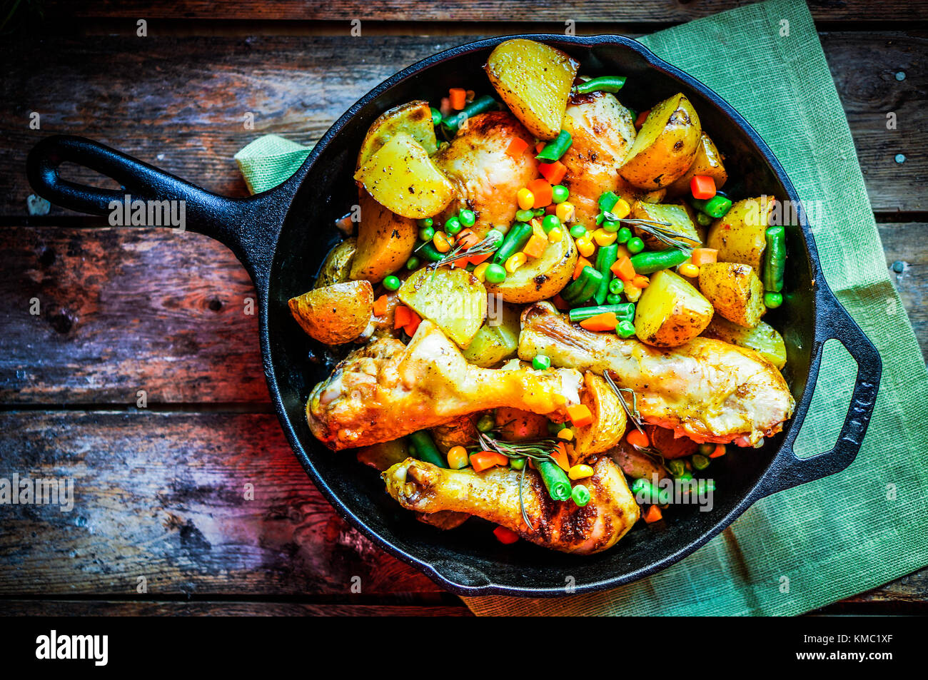 Oven Baked Chicken With Potatoes And Vegetables On Wooden Background