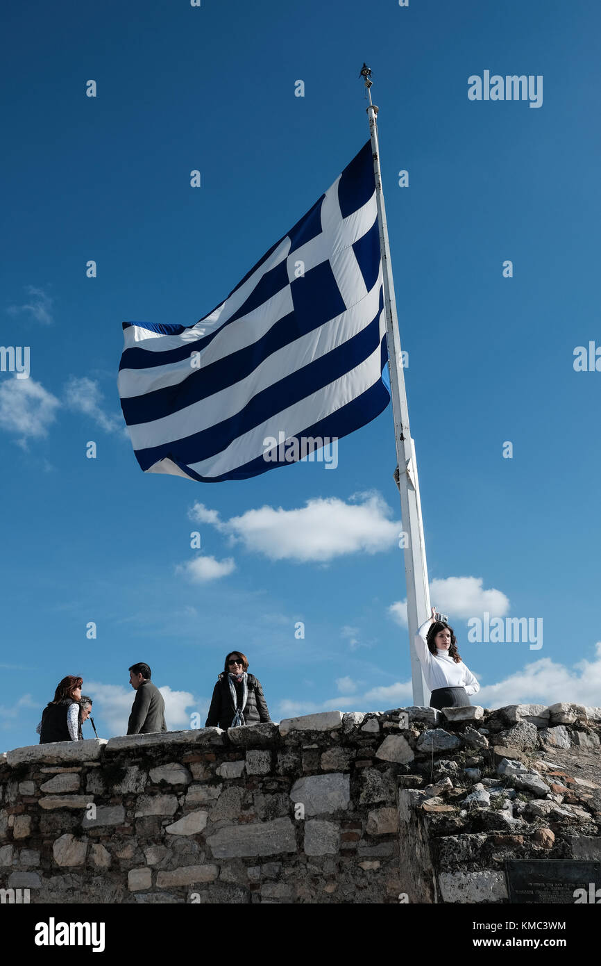The flag of Greece flies high on the Acropolis of Athens, a UNESCO World Heritage Site. Stock Photo