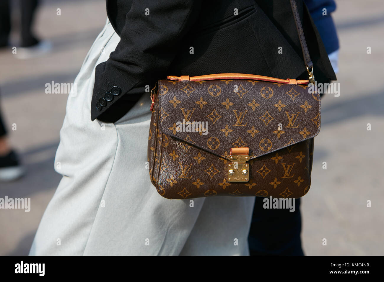 MILAN - SEPTEMBER 23: Woman with Louis Vuitton bag with black jacket and  gray trousers before Gabriele Colangelo fashion show, Milan Fashion Week  stre Stock Photo - Alamy