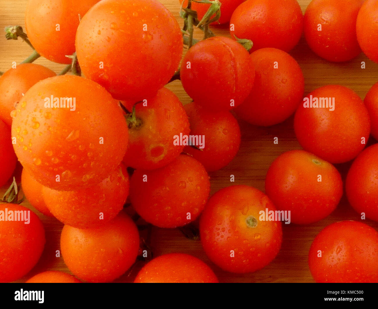 Cherry tomatoes on wooden plank isolated Stock Photo - Alamy