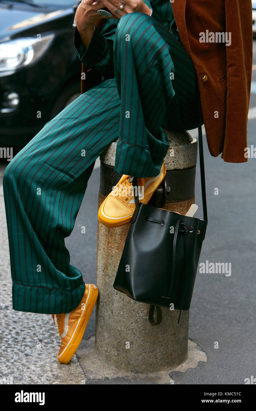 MILAN - SEPTEMBER 23: Woman with green silk trousers and yellow Vans shoes  before Antonio Marras fashion show, Milan Fashion Week street style on Sept  Stock Photo - Alamy