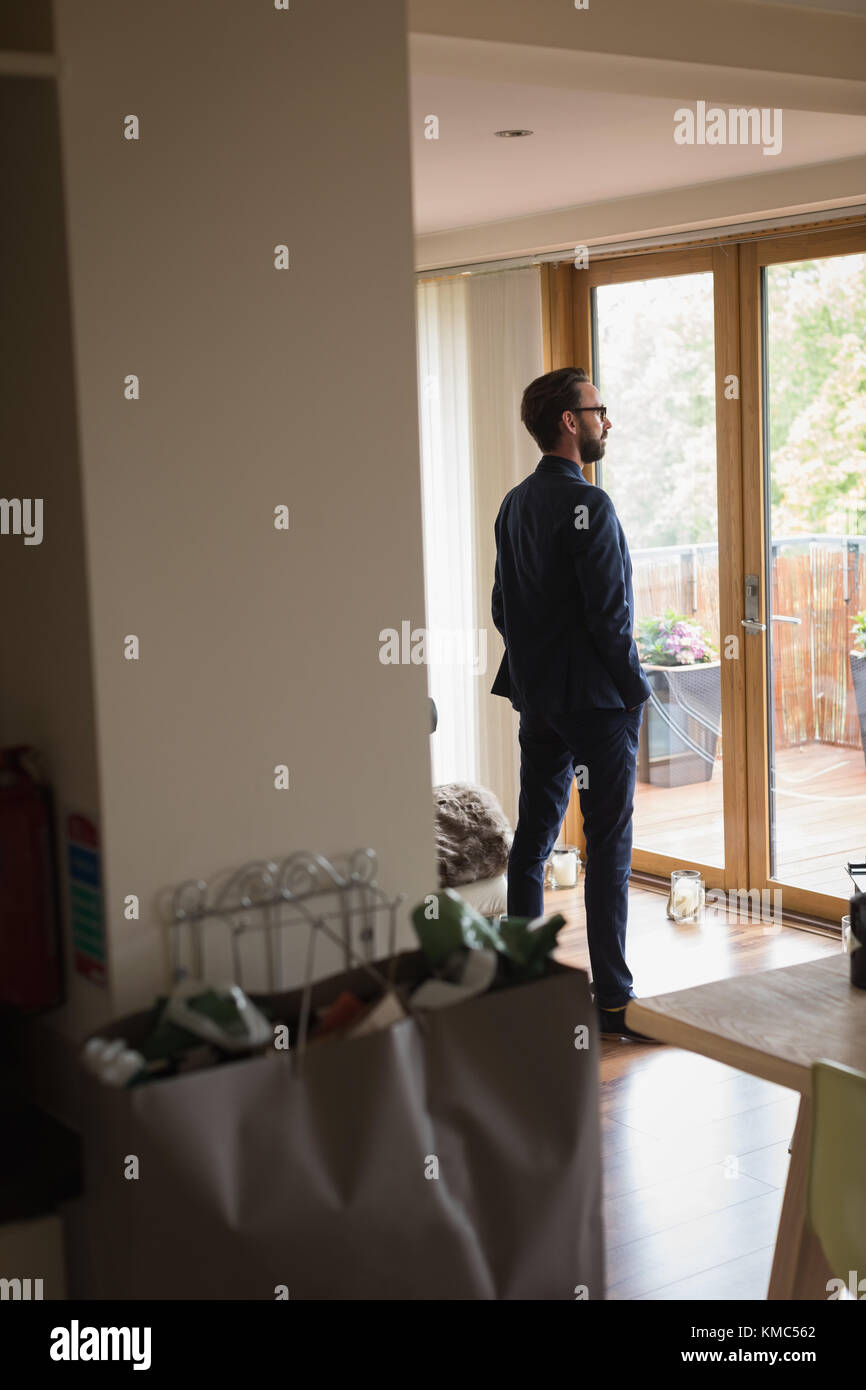 Man in full suit standing at home Stock Photo