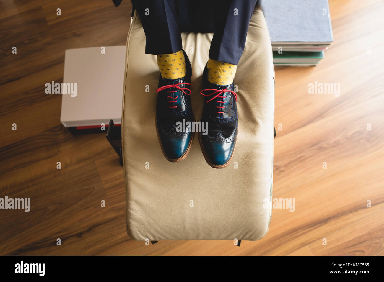 Man in black formal shoes relaxing in living room Stock Photo