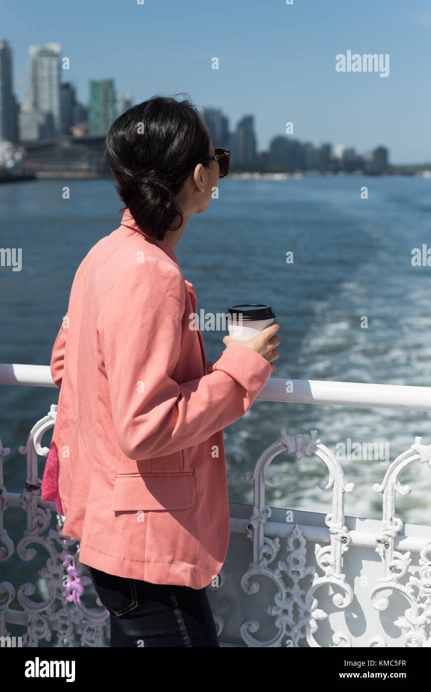 Woman in ferry looking at the sea Stock Photo - Alamy