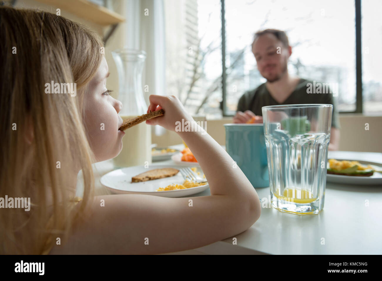 Father and daughter having breakfast Stock Photo