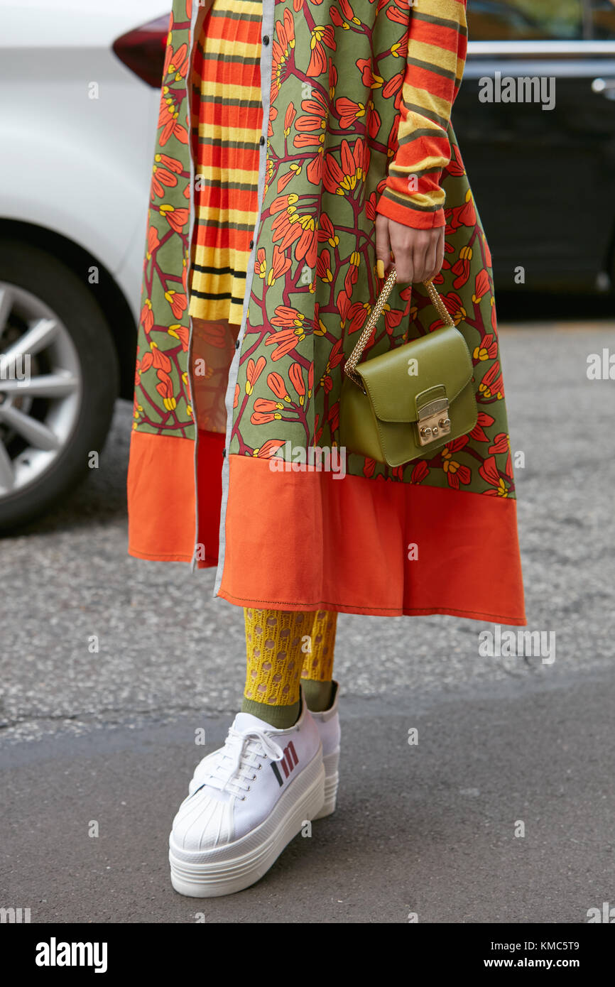 MILAN - SEPTEMBER 23: Woman with green Furla bag, orange and yellow jacket  and white wedge heel shoes before Antonio Marras fashion show, Milan Fashio  Stock Photo - Alamy