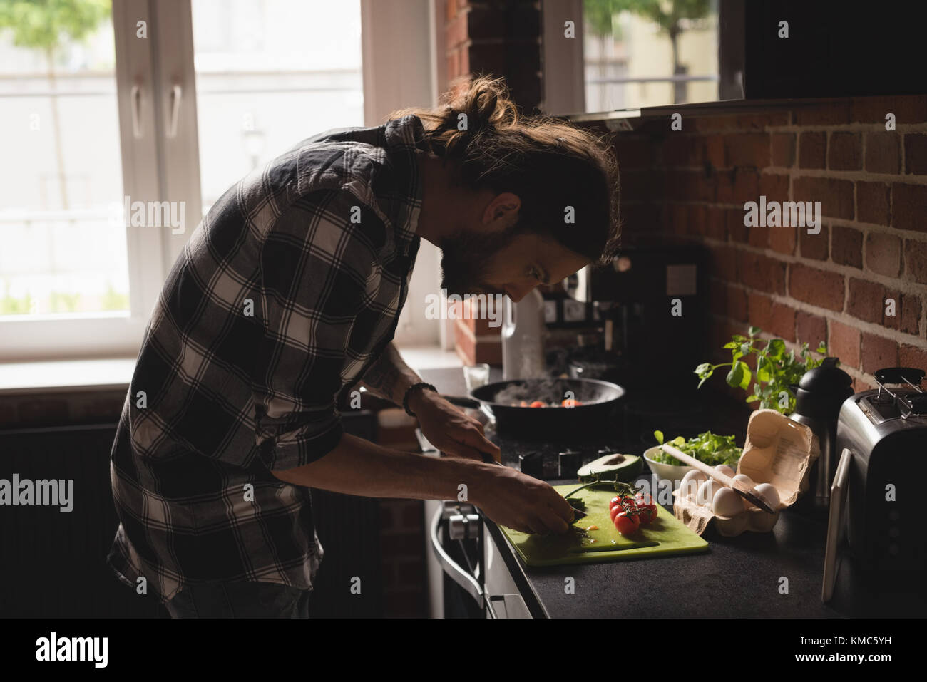 Man preparing food in kitchen Stock Photo