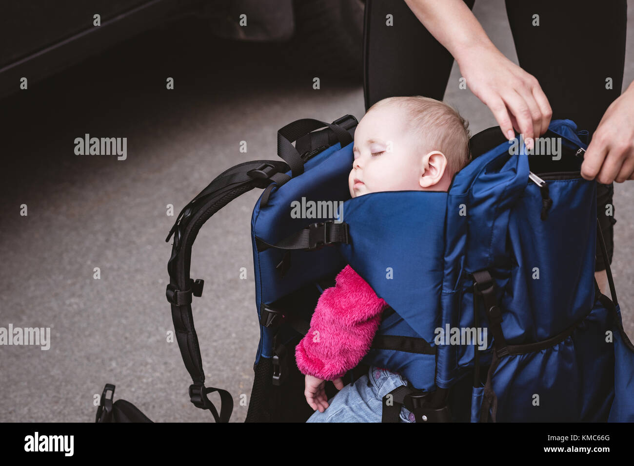 Baby taking a nap in the backpack carrier Stock Photo - Alamy