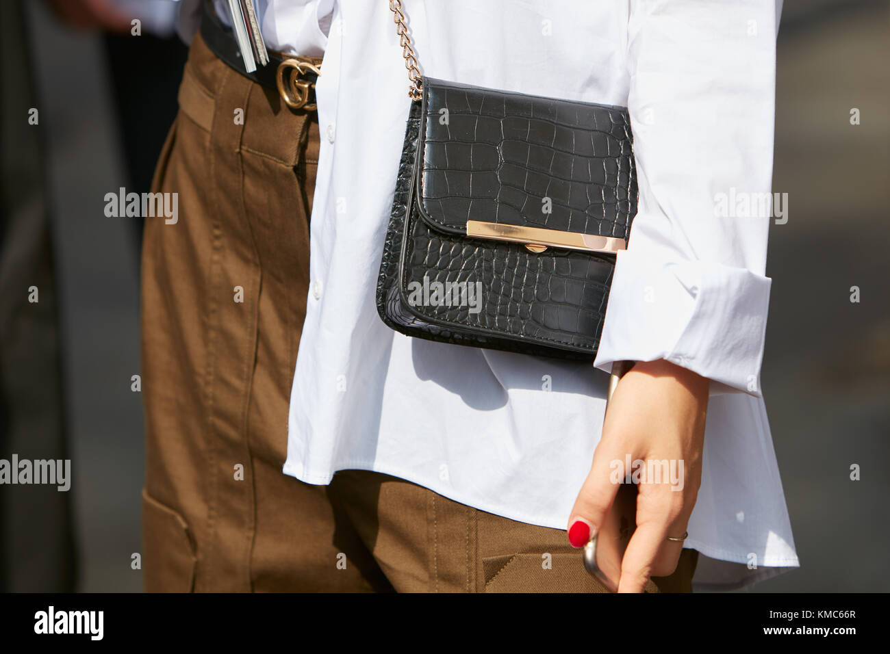 MILAN, ITALY - SEPTEMBER 22, 2018: Woman with black leather Dior bag, Gucci  belt and Louis Vuitton smartphone cover before Philosophy fashion show, Mi  Stock Photo - Alamy