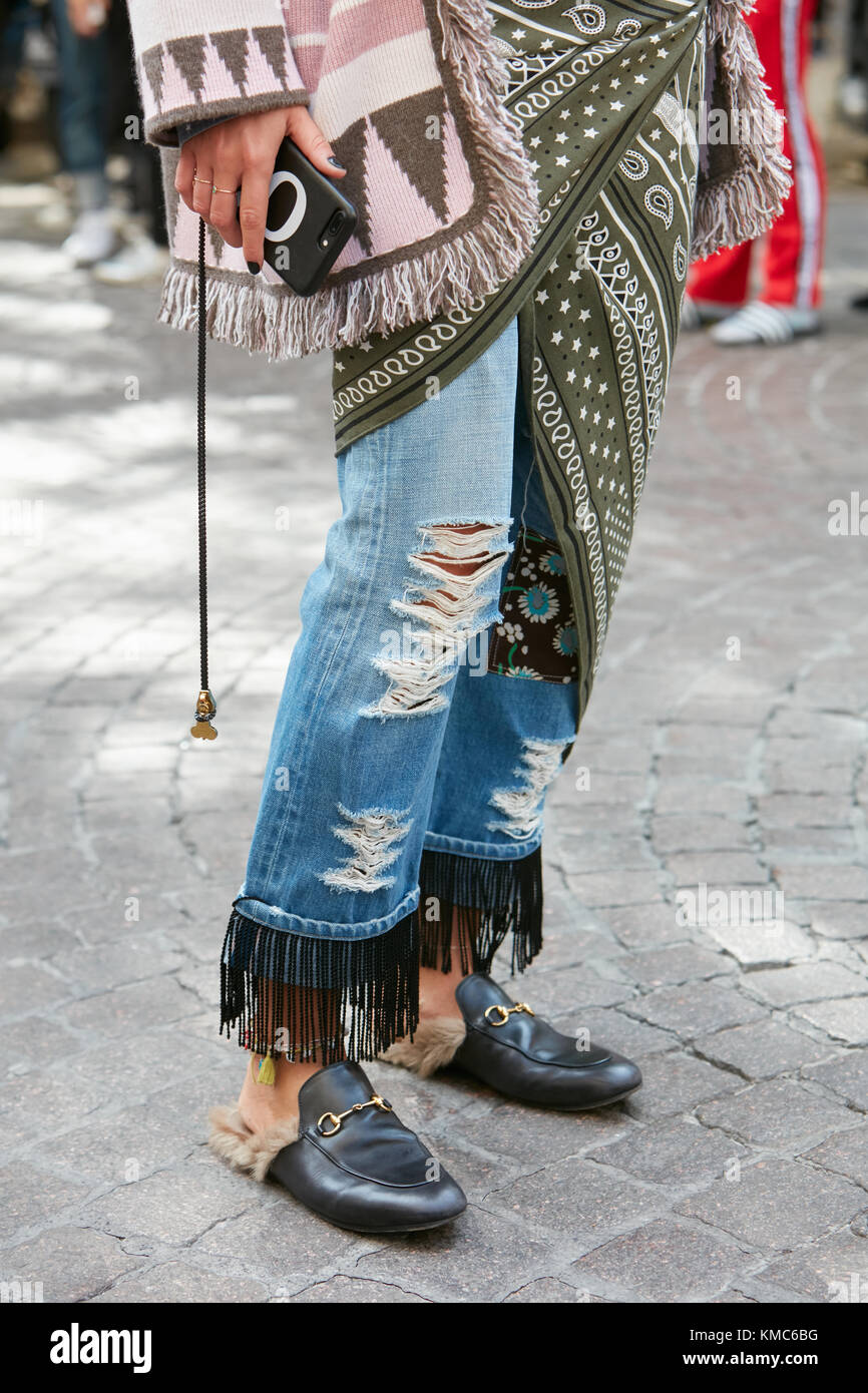 MILAN - SEPTEMBER 23: Woman with torn blue jeans with fringes and Gucci  shoes before Blumarine fashion show, Milan Fashion Week street style on  Septem Stock Photo - Alamy