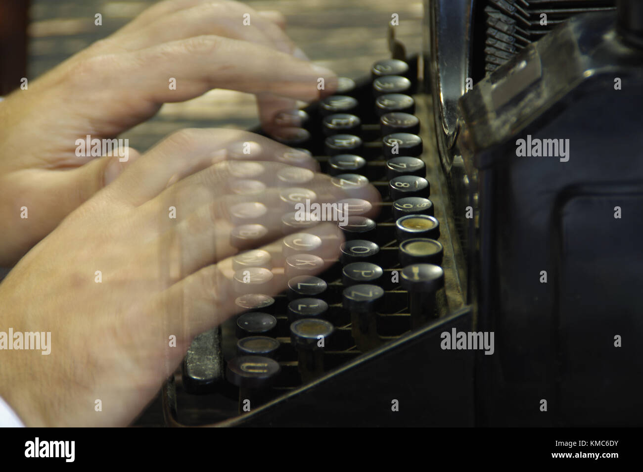 Fingers printed on old writing machine. Moved picture of the hands over the typing keyboard. Stock Photo