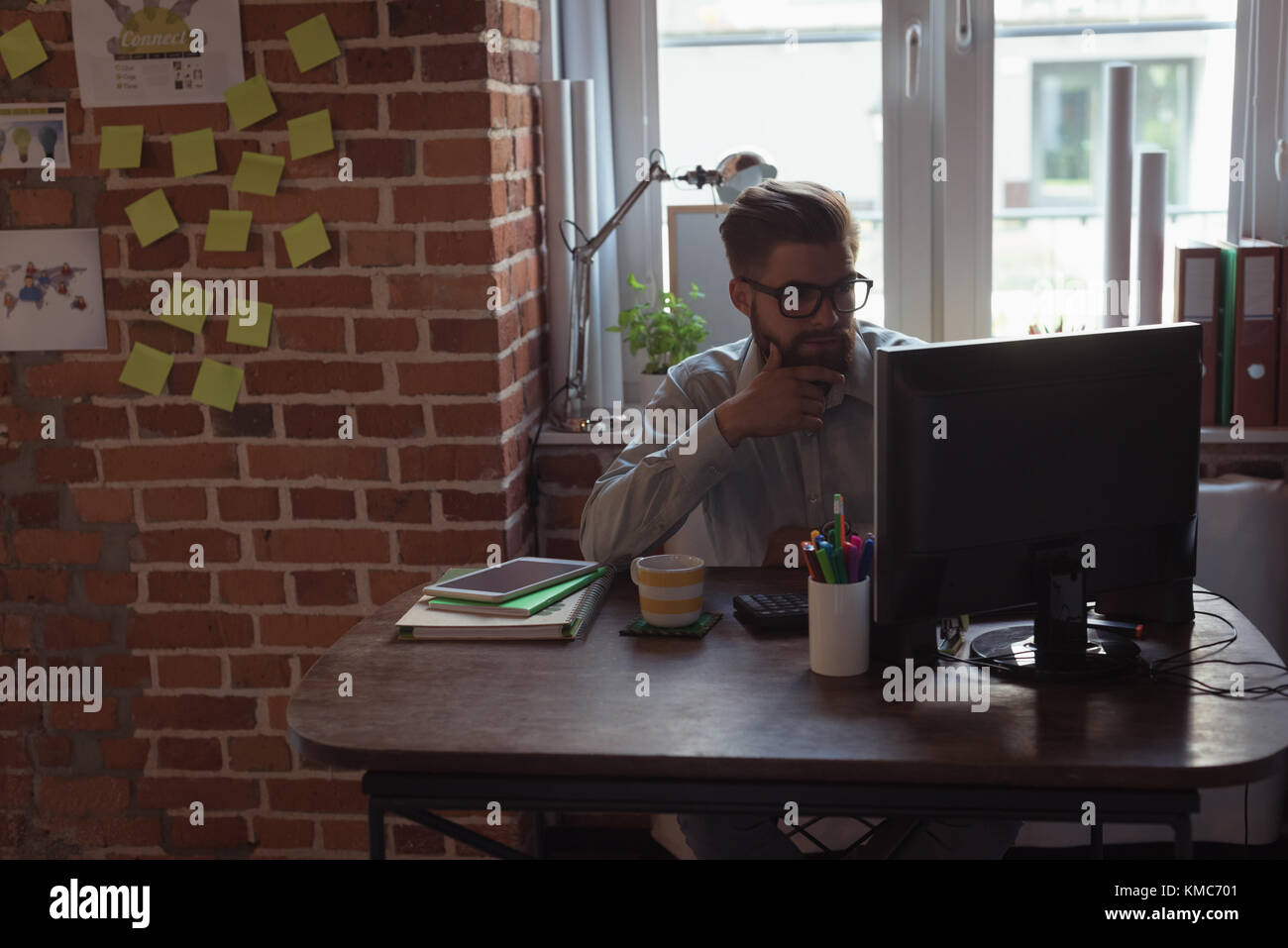 Executive working on computer Stock Photo - Alamy
