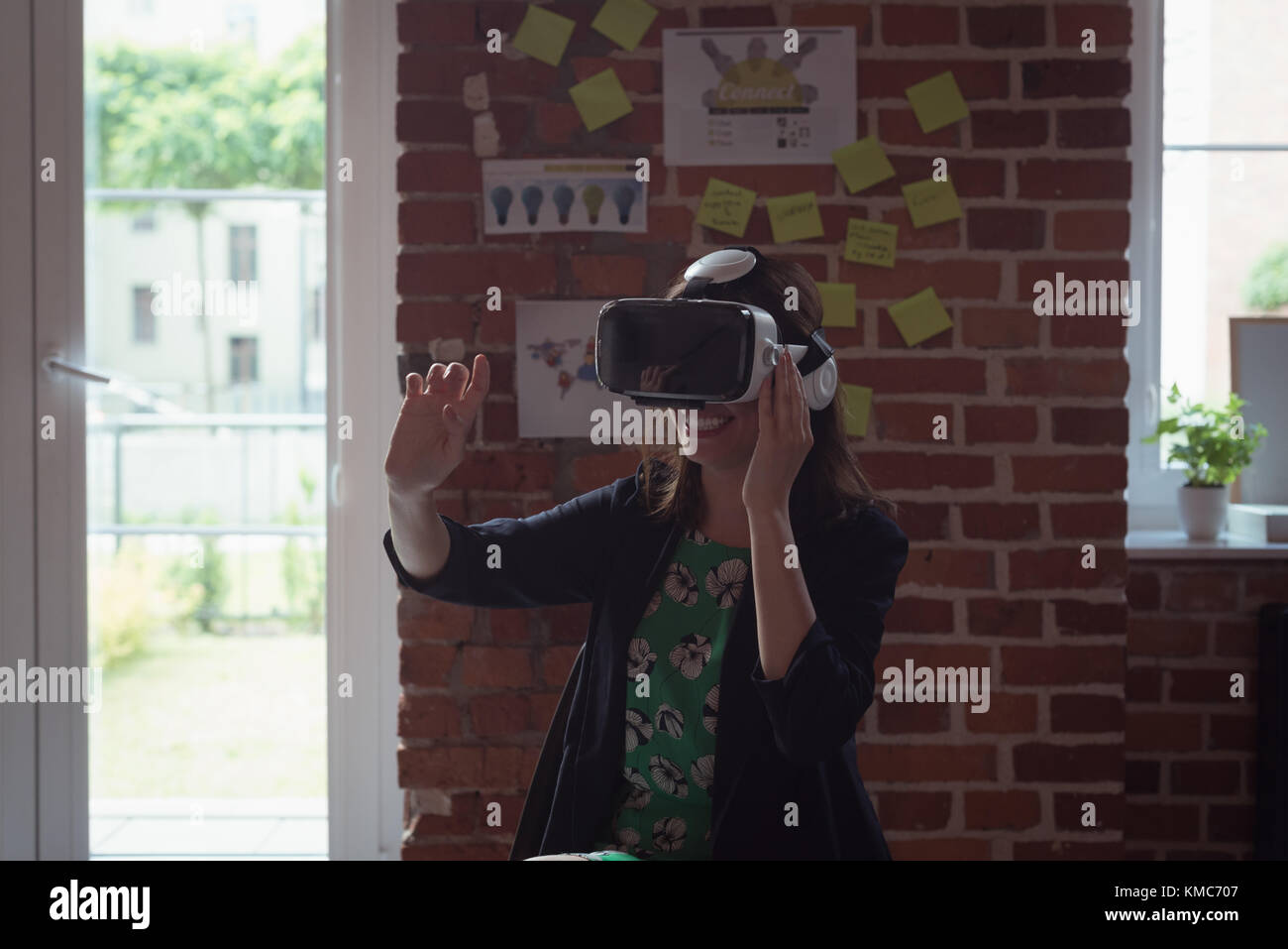 Female executives using virtual reality headset in office Stock Photo ...