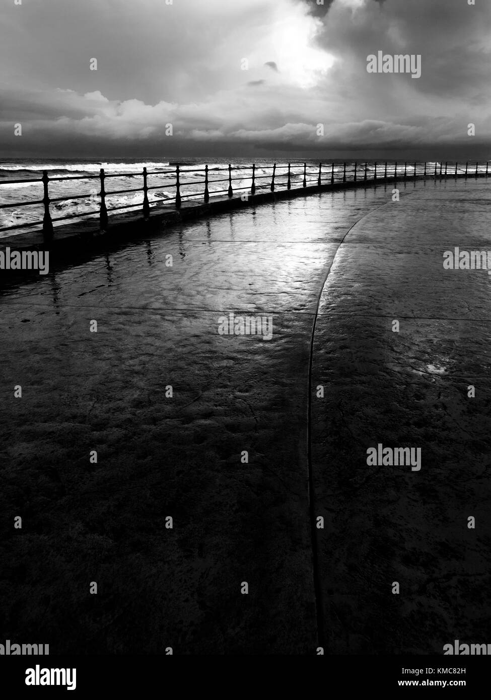 Iron Railings on the Sea Wall and Reflections after Rain in Souith Bay Scarborough North Yorkshire England Stock Photo