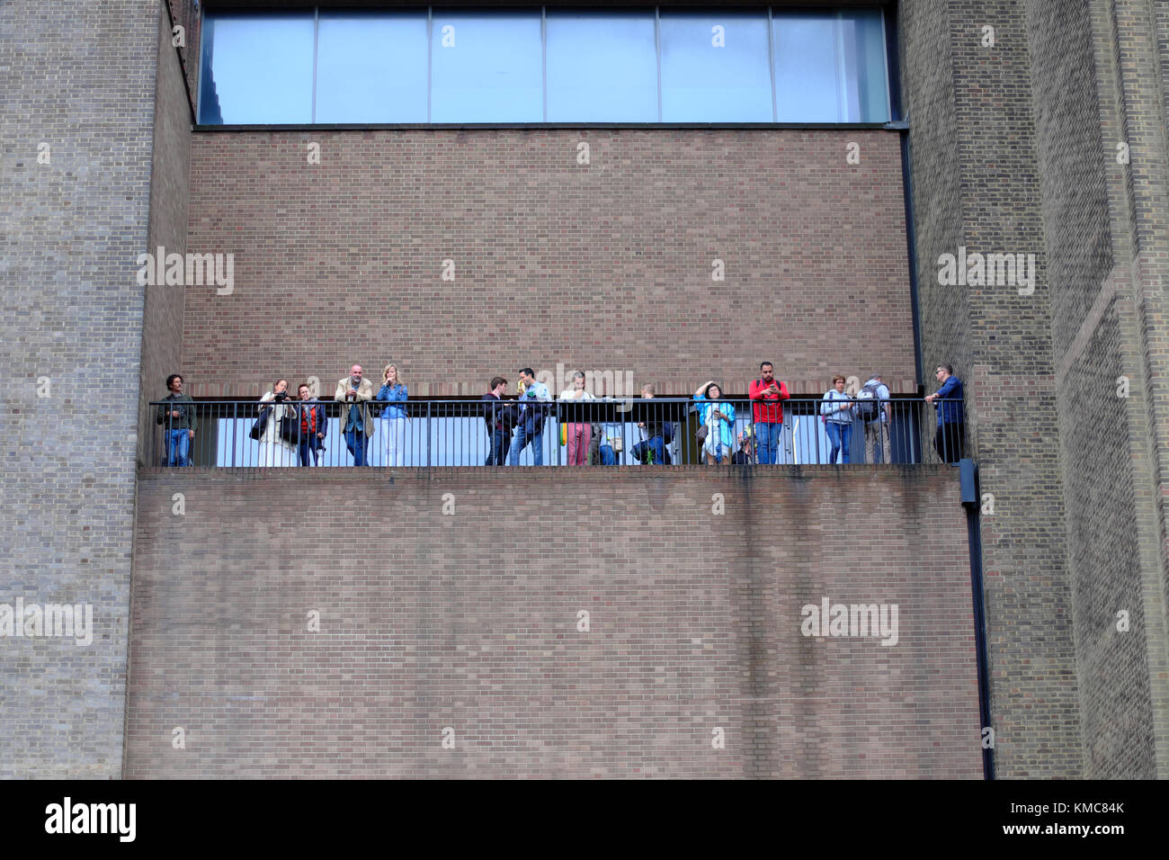 people sightseeing from a hign balcony at the Tate modern Gallery in London, England, UK (taken from public area) Stock Photo