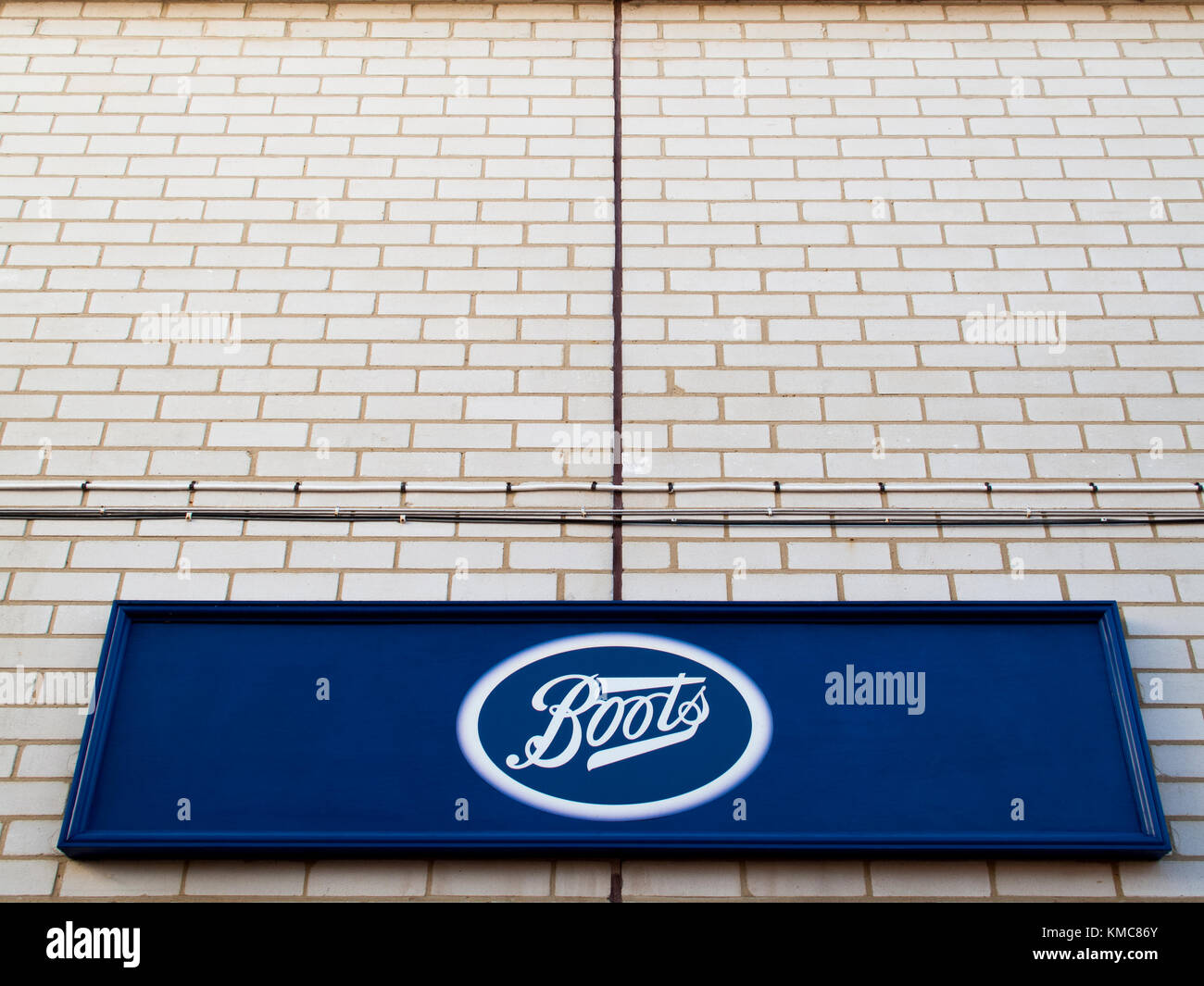 Boots the chemist sign on brick wall hires stock photography and