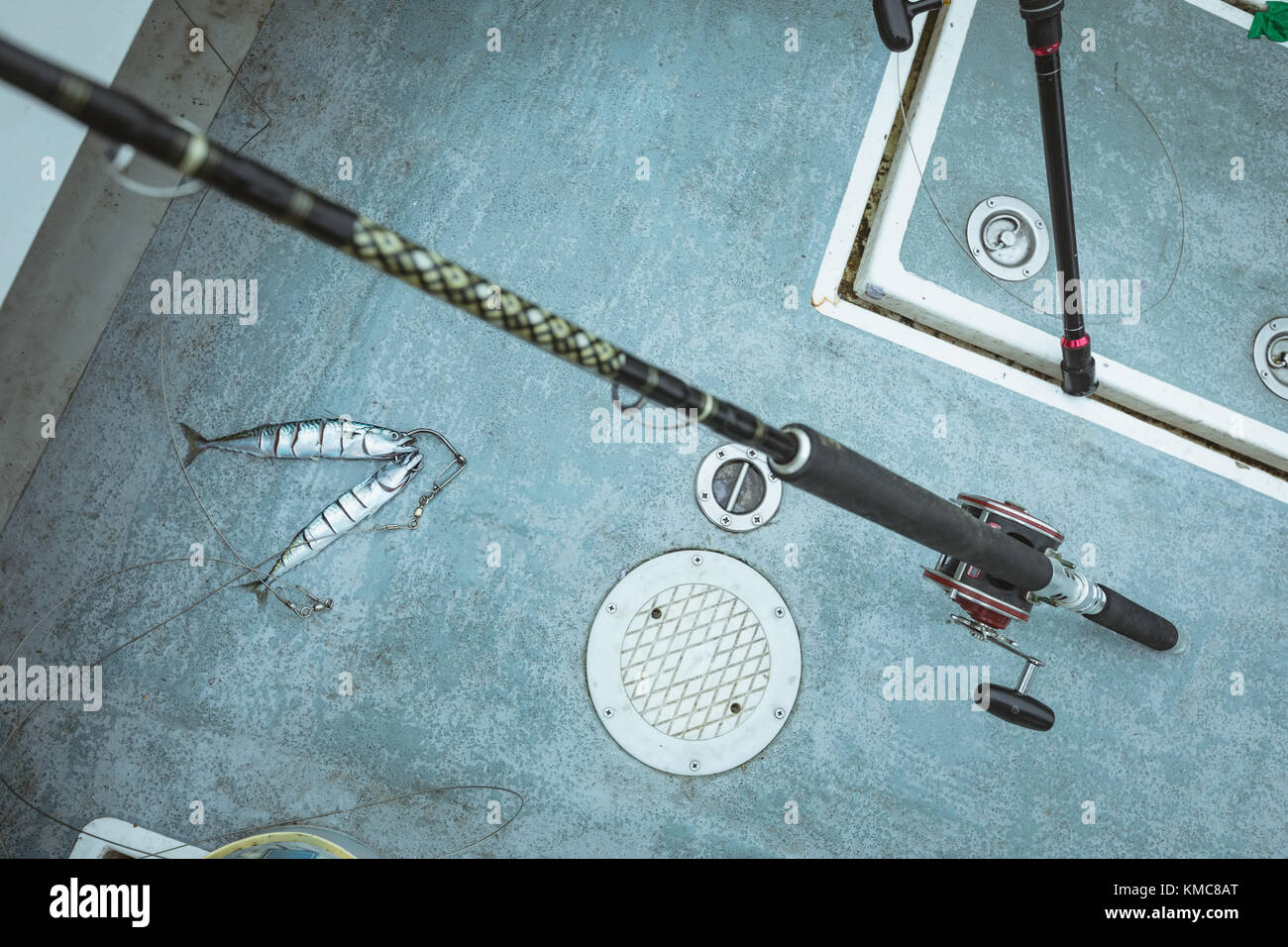 Fillet of fish and fishing rod on boat Stock Photo