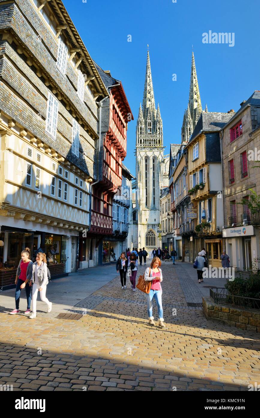 Cathedral of Saint Corentin seen beyond shops on Rue Kereon in the mediaeval city centre of Quimper, Finistere, Brittany, France Stock Photo