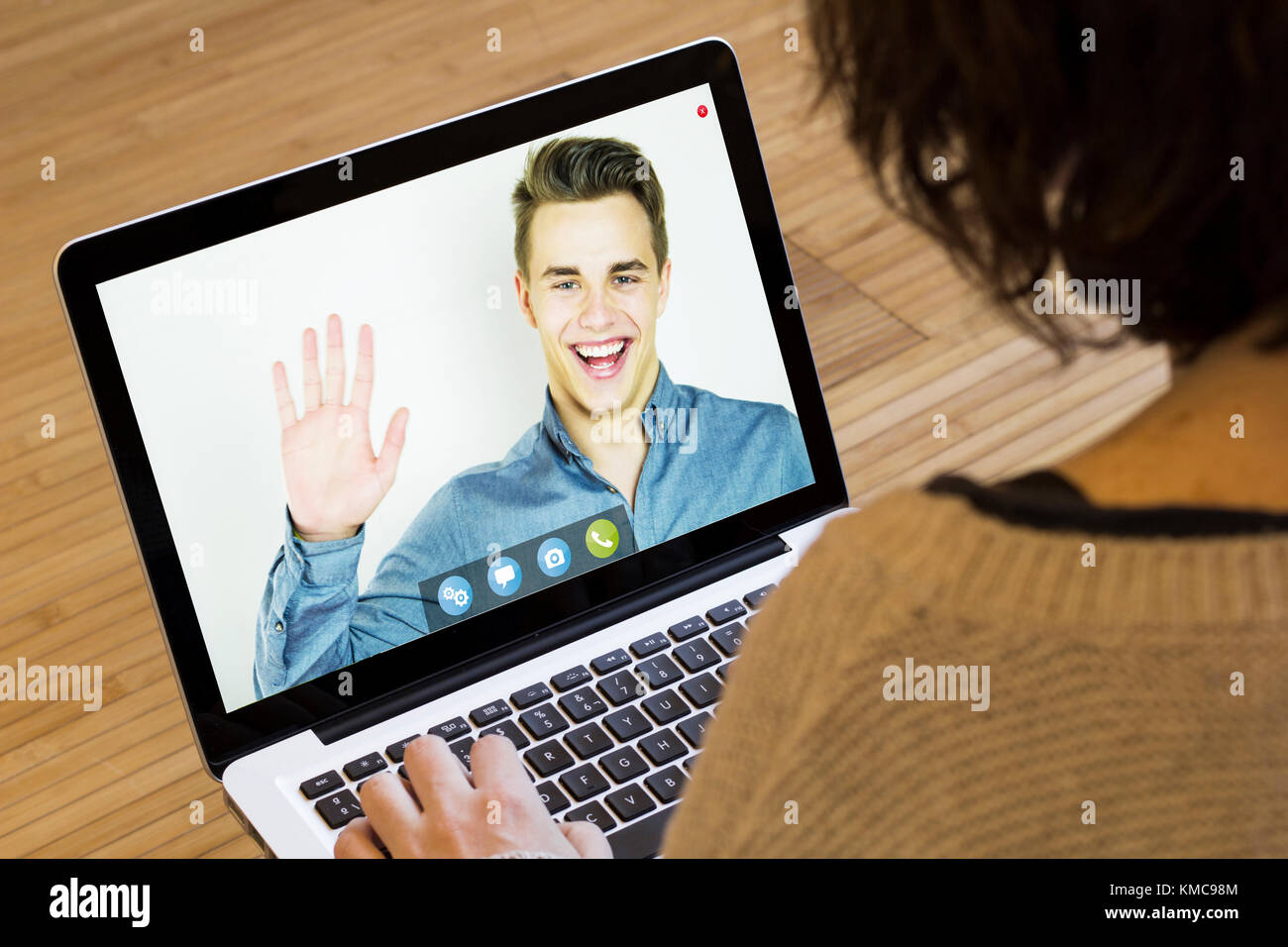 online business concept: businessman saying hello on a laptop screen. Screen graphics are made up. Stock Photo