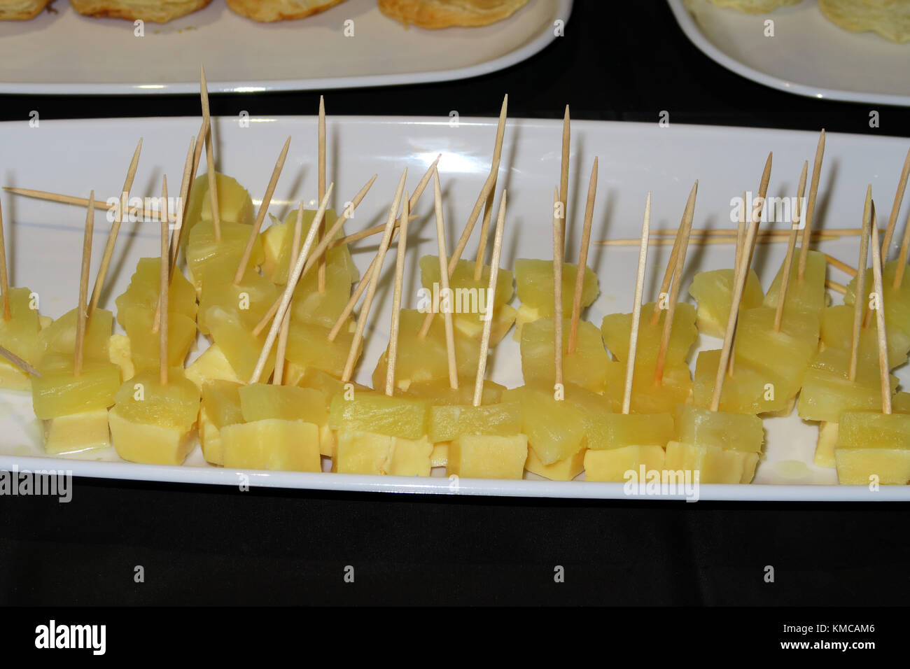 A tasty tray of cheese chunks and pineapple chunks on sticks Stock ...