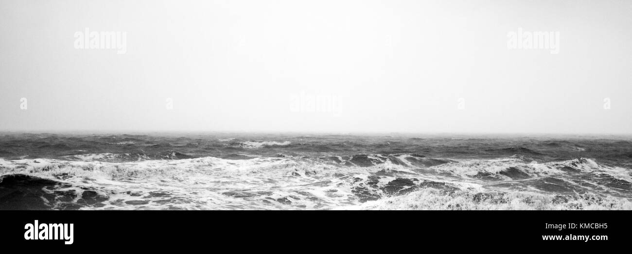 black and white contrast sea view seascape of the white waves crashing at blackpool, uk, from the promenade Stock Photo