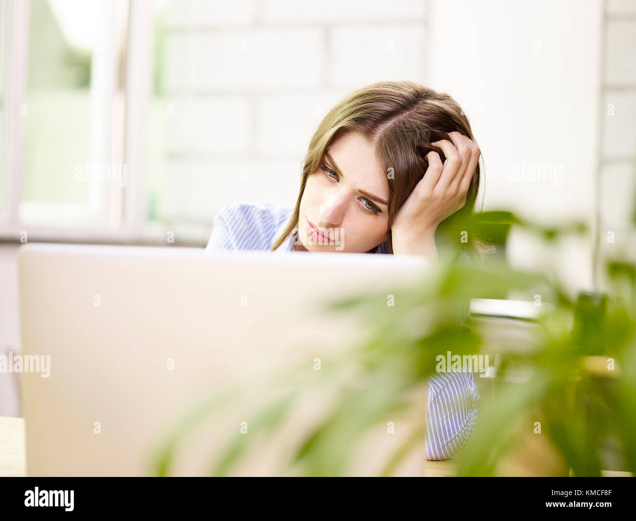 young caucasian business woman working in office using laptop computer, looking tired and frustrated. Stock Photo