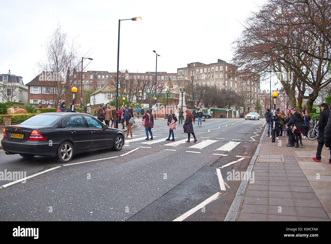 LONDON CITY - DECEMBER 25, 2016: People stopping traffic by walking on the crossing over Abbey Road like the cover from the Beatles Stock Photo