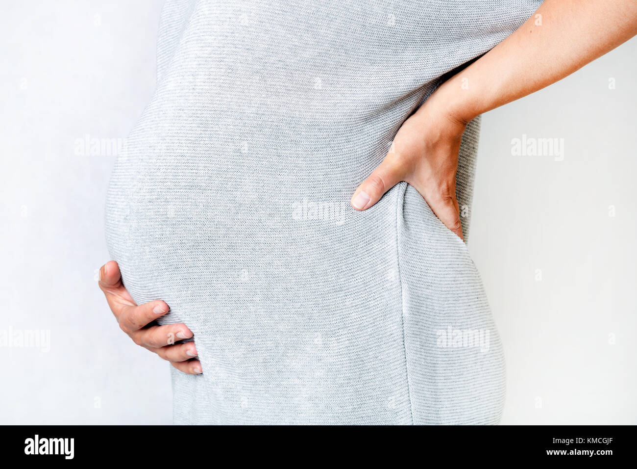 Pregnant woman with stomach pain or back aches, concept of aches in