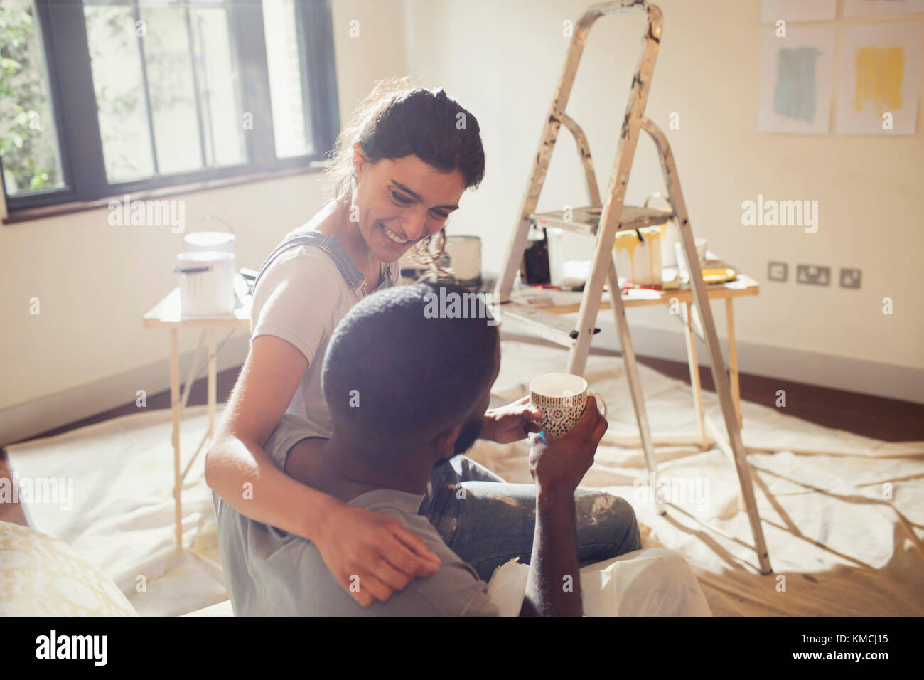 Affectionate young couple painting living room Stock Photo