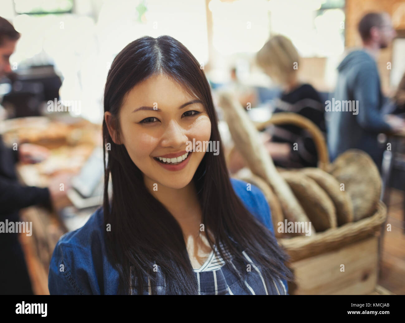 Portrait smiling young woman in grocery store Stock Photo
