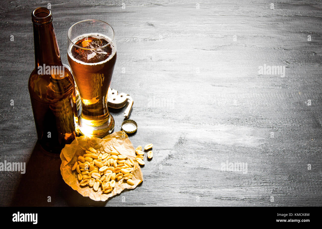 Beer background. Beer with peanuts on the black wooden table. Free space  for text Stock Photo - Alamy