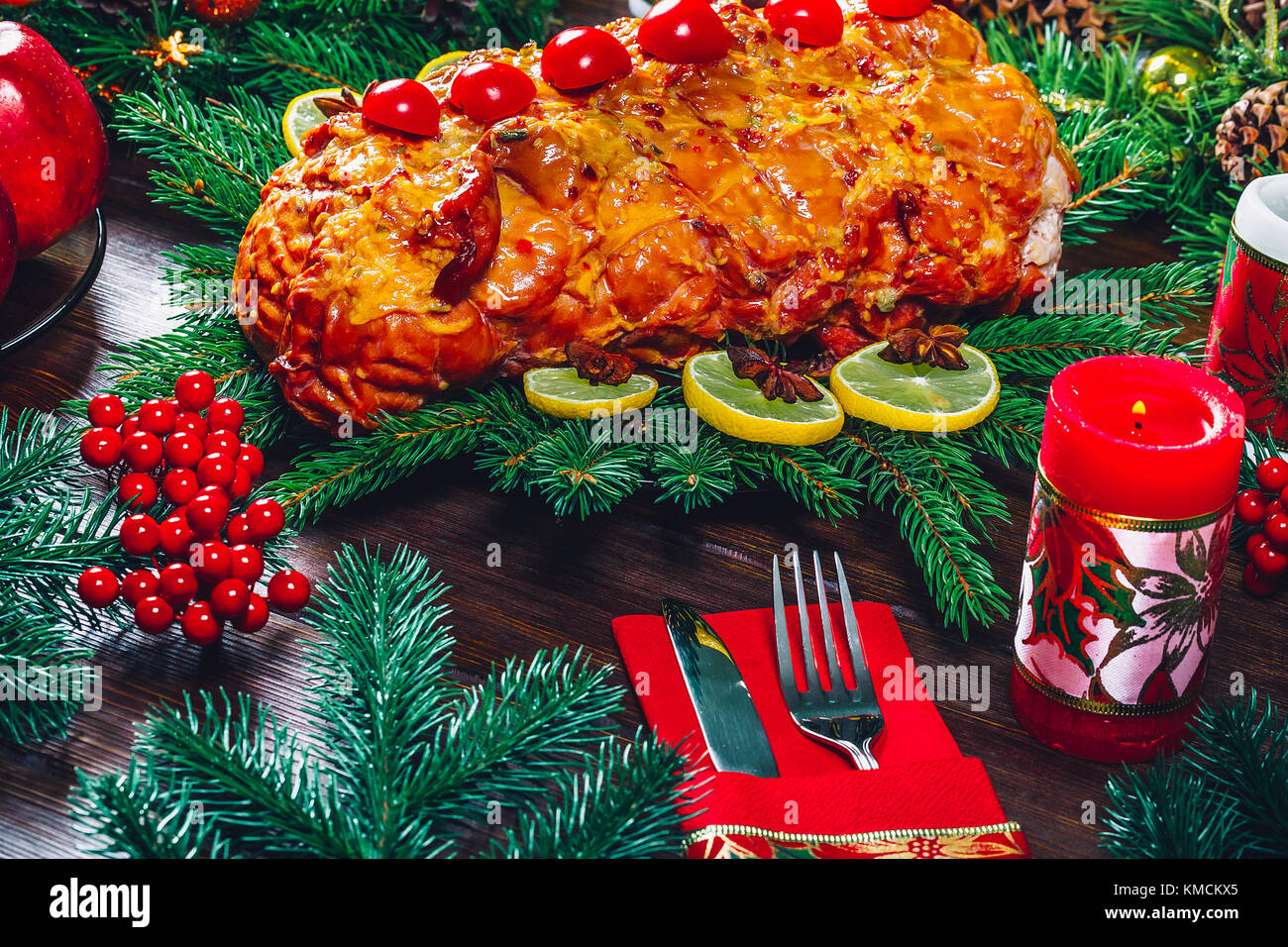 Christmas table dinner time with roasted meats, candles and New Year decor. Background thanksgiving. The concept of a family holiday Stock Photo