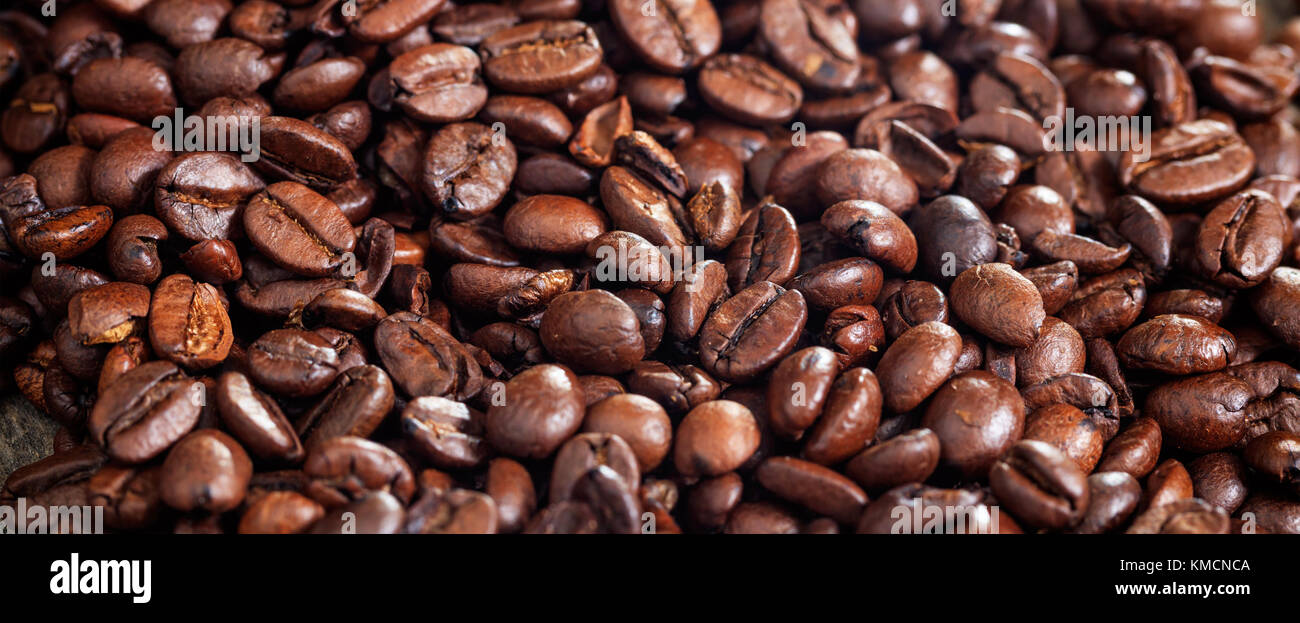 Brown roasted coffee beans background. Close up view with details Stock ...