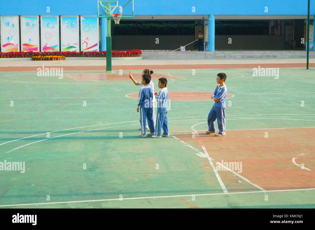 In the primary school playground, primary school students are taking sports classes and skipping rope. In Shenzhen, China. Stock Photo