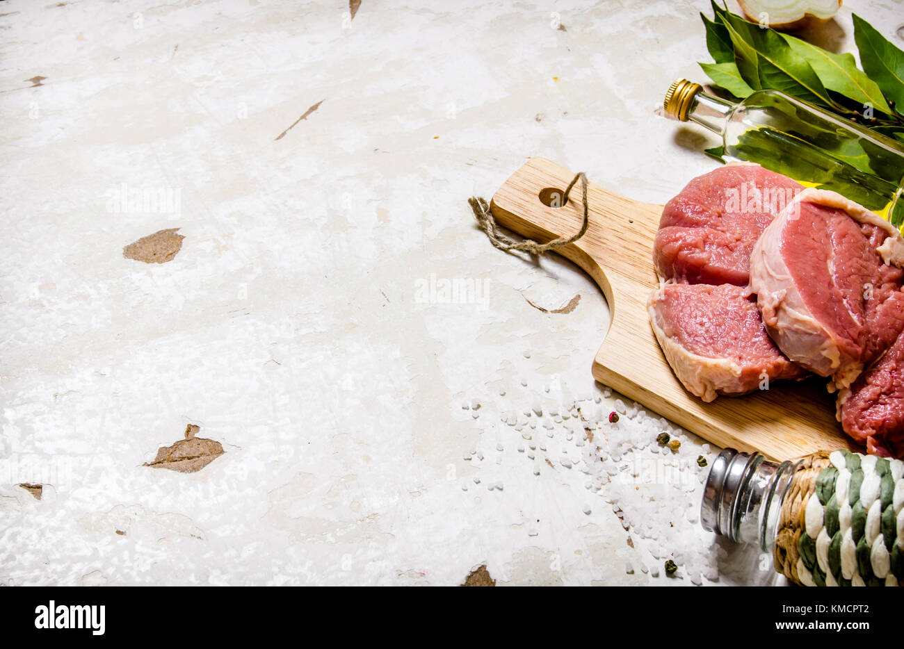 Raw fresh meat on board with spices. On rustic background. Free space ...