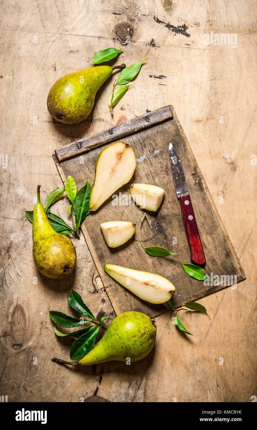 Pears with leaves on chopping board hi-res stock photography and images ...