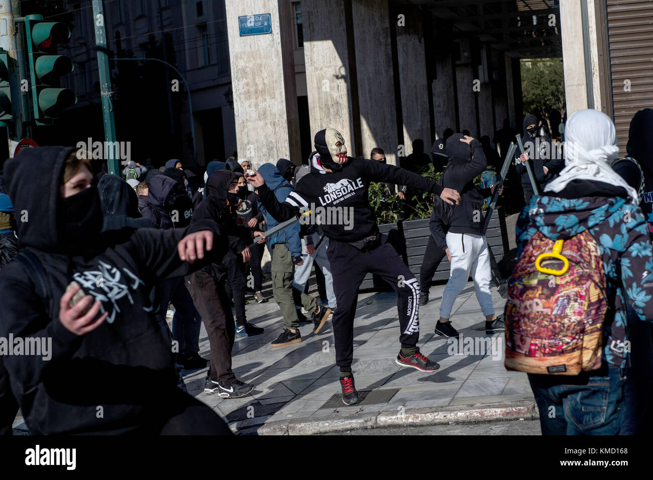 Athens, Greece. 6th Dec, 2017. Masked people can be seen partaking in a protest match in Athens, Greece, 6 December 2017. The ninth anniversary of the death of a 15 year old by police bullet was marked by riots. Some 200 masked persons threw stones against the police, devastated shops and cafés and lit some trash containers on fire. Credit: Angelos Tzortzinis/dpa/Alamy Live News Stock Photo