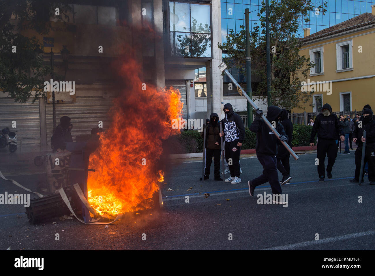 Athens, Greece. 6th Dec, 2017. Masked people can be seen partaking in a protest match in Athens, Greece, 6 December 2017. The ninth anniversary of the death of a 15 year old by police bullet was marked by riots. Some 200 masked persons threw stones against the police, devastated shops and cafés and lit some trash containers on fire. Credit: Angelos Tzortzinis/dpa/Alamy Live News Stock Photo