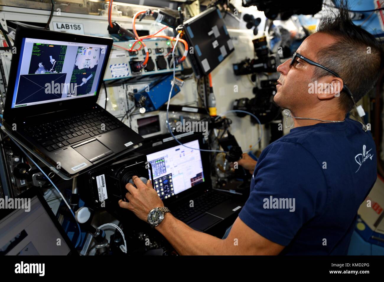 Expedition 53 American astronaut Joe Acaba practices using the controls of the robotic Canada Arm 2 prior to the release of the Orbital ATK Cygnus cargo spacecraft from the International Space Station December 6, 2017 in Earth Orbit. Cygnus will deployed 14 CubeSats from the NanoRacks deployer and will later be burned up on destructive reentry in the Earth atmosphere. Stock Photo