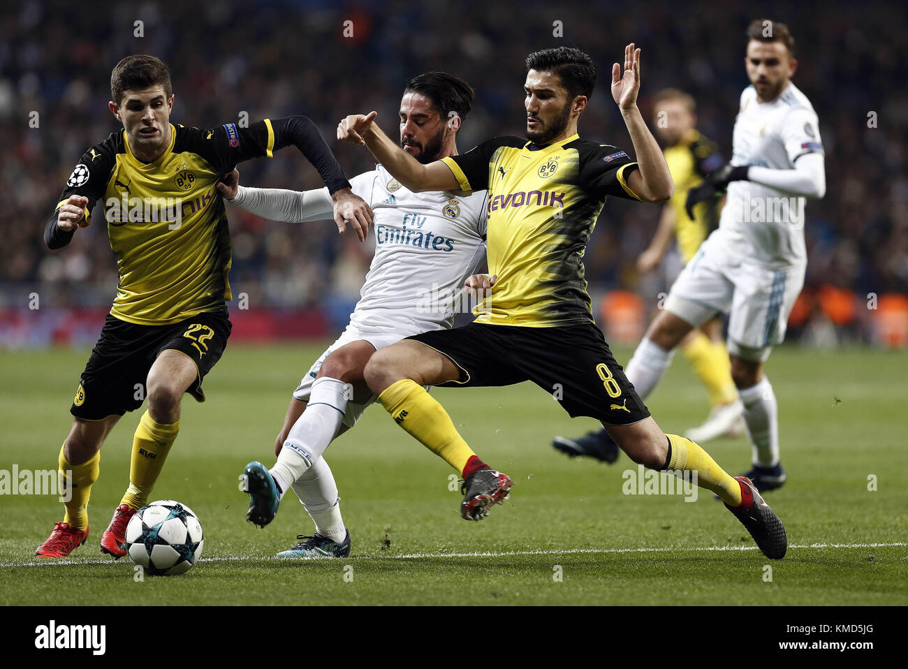 Madrid, Spain. 6th Dec, 2017. Isco of Real Madrid is challenged by Sahin of Borussia Dortmund during the UEFA Champions League group H match between Real Madrid and Borussia Dortmund at Santiago Bernabéu. Credit: Manu reino/SOPA/ZUMA Wire/Alamy Live News Stock Photo