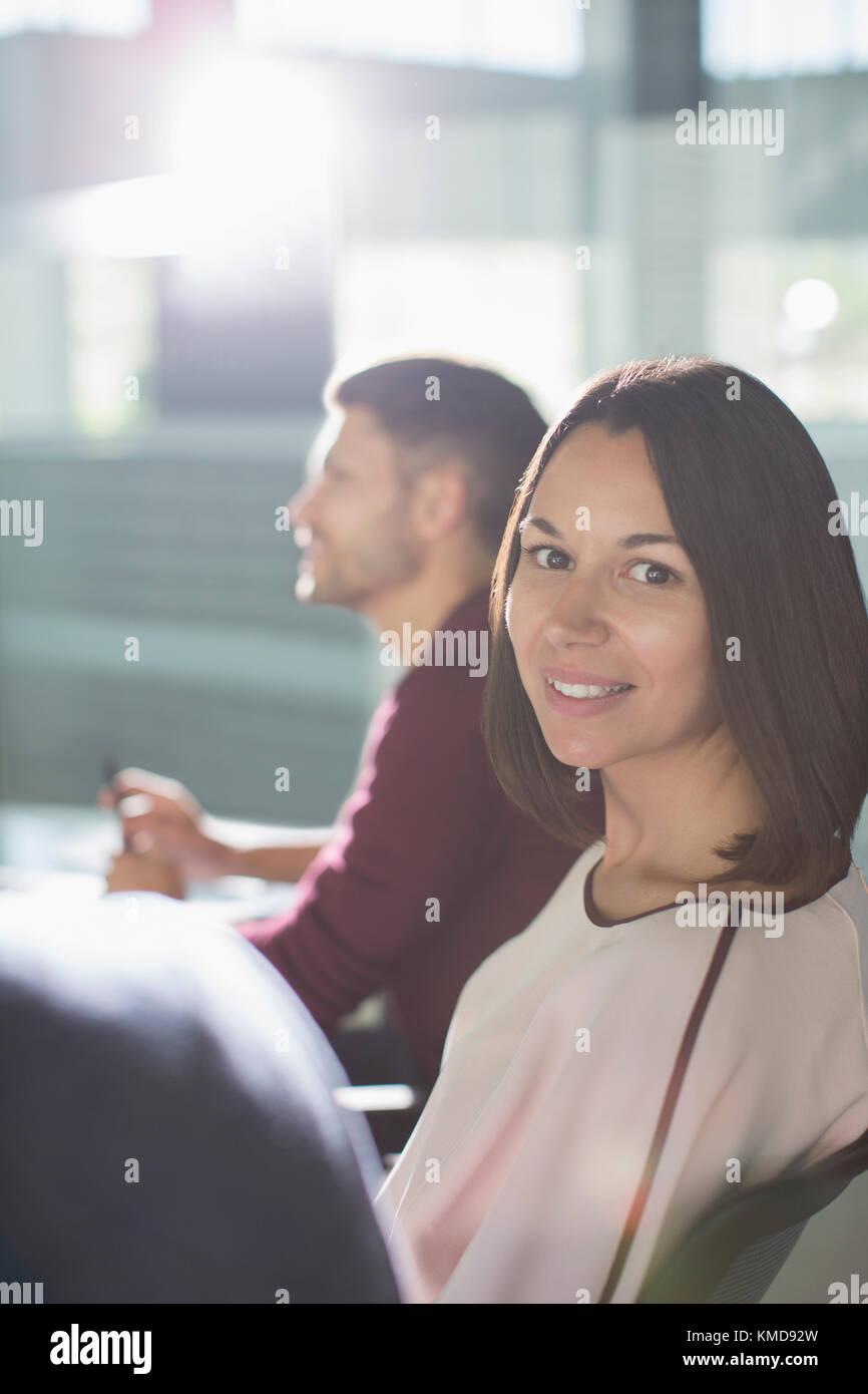 Portrait smiling brunette businesswoman in meeting Stock Photo