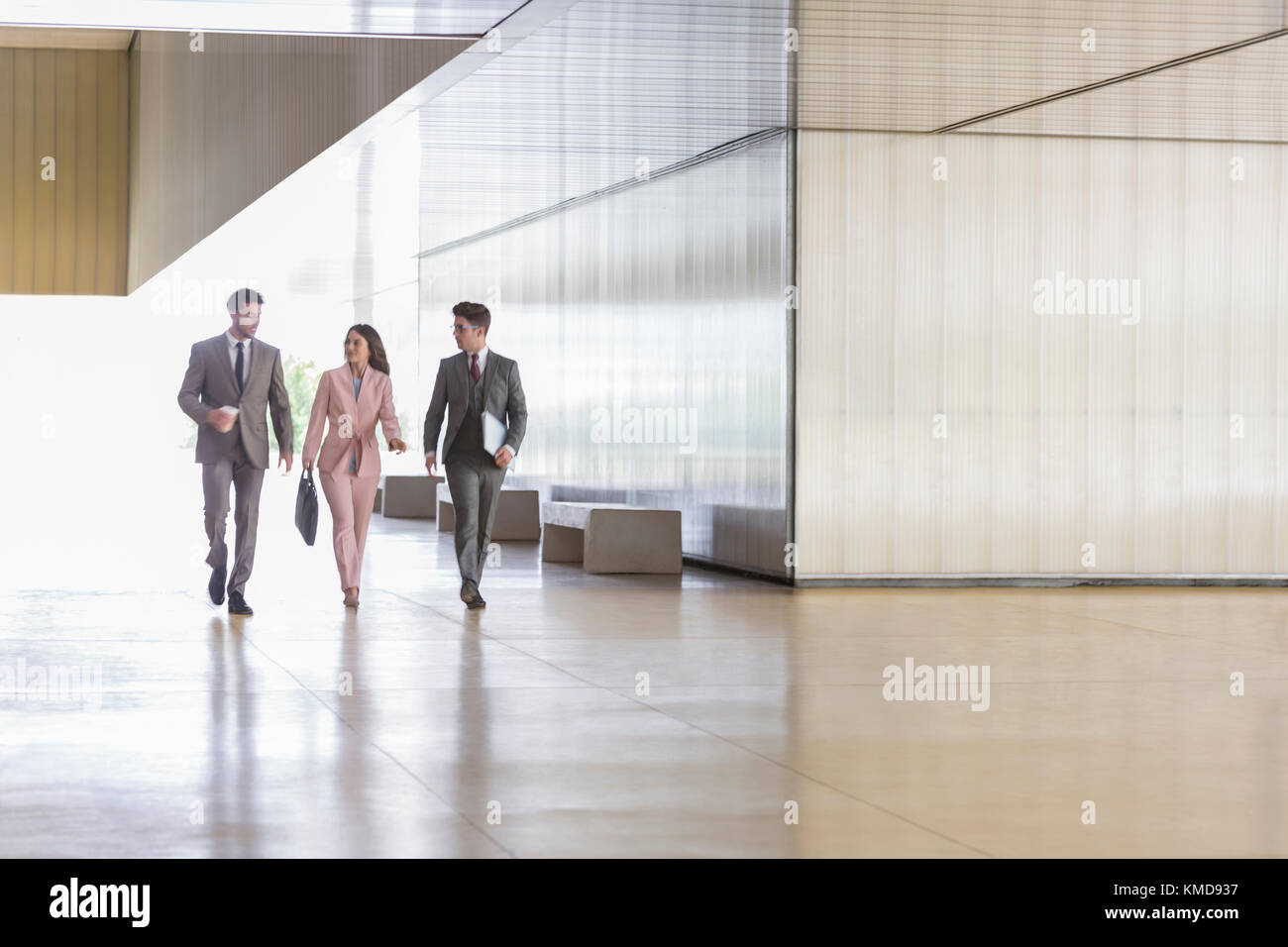 Business people walking an talking in modern office corridor Stock ...