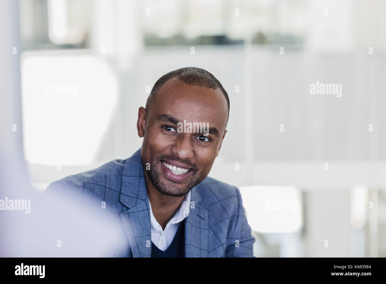 Smiling,enthusiastic businessman listening in meeting Stock Photo