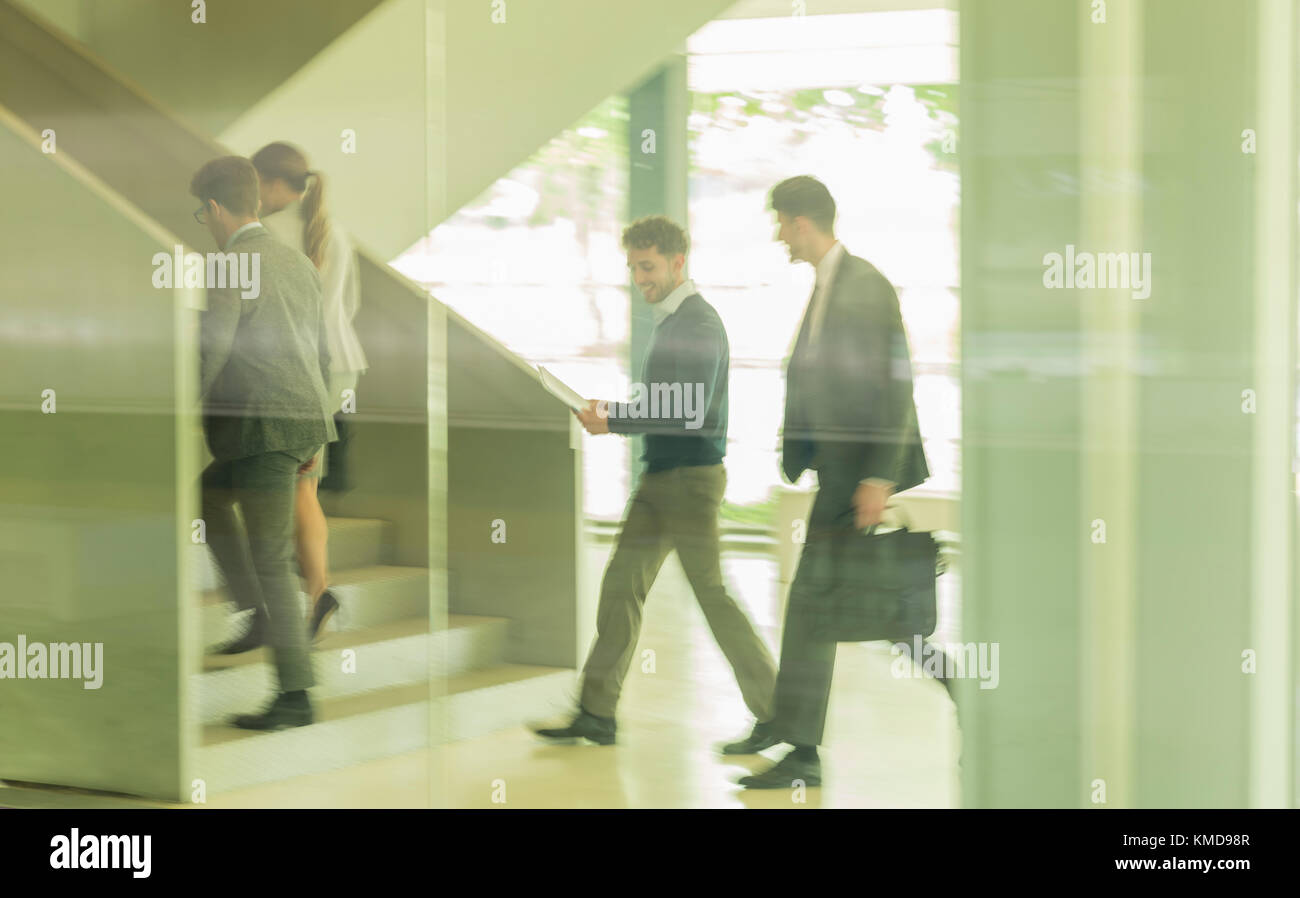 Business people walking,ascending stairs in office Stock Photo
