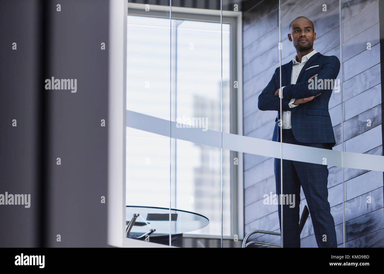 Serious,confident CEO businessman standing at modern office window Stock Photo