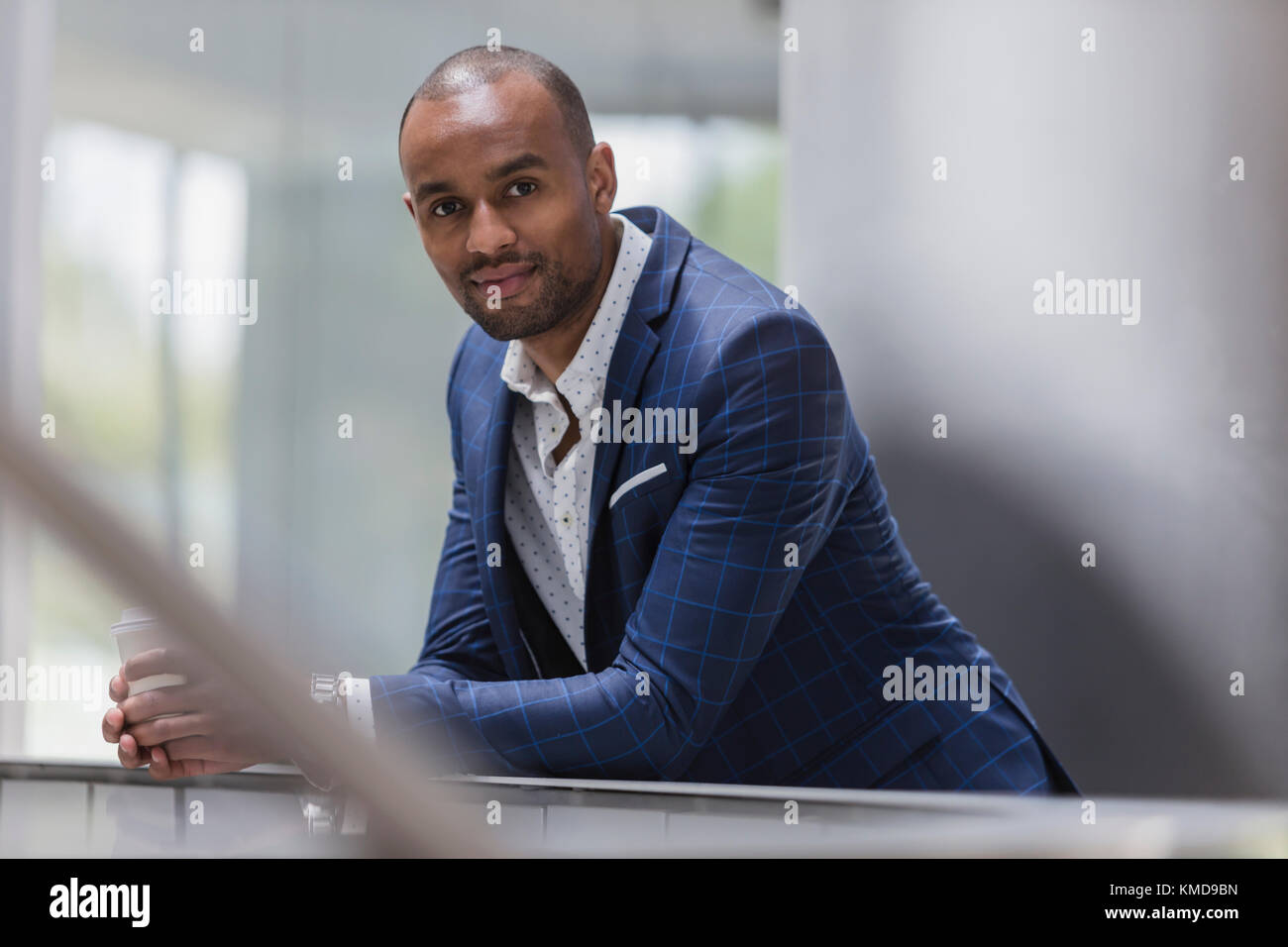 Portrait confident businessman leaning on railing Stock Photo